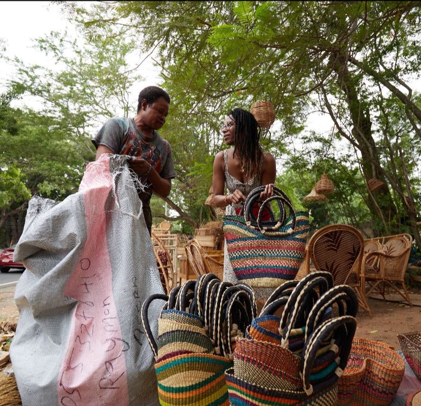 Nasozi and Adongo discuss their first Bolga baskets order following his interview for the book in Accra.