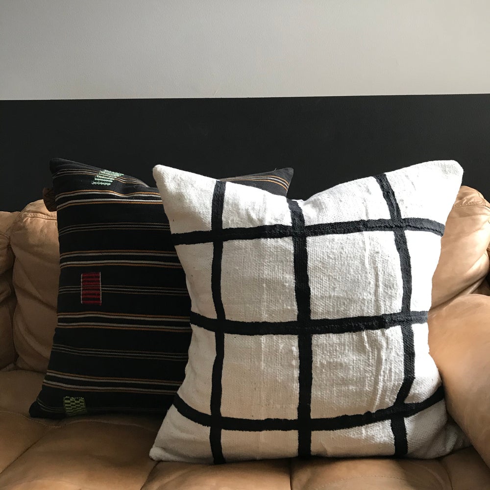 Handpainted white mudcloth pillows with black minimalist design. Made in USA, designed in Mali.