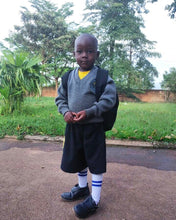 Load image into Gallery viewer, Our social impact work benefits the children of Mukono, Uganda. Obo is one of our primary education scholarship recipients.
