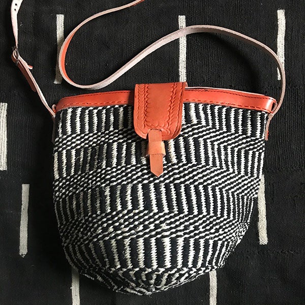 Black and white handcrafted woven raffia and leather tote made in Uganda, Fair Trade. Perfect for daily essentials and accessorizing.