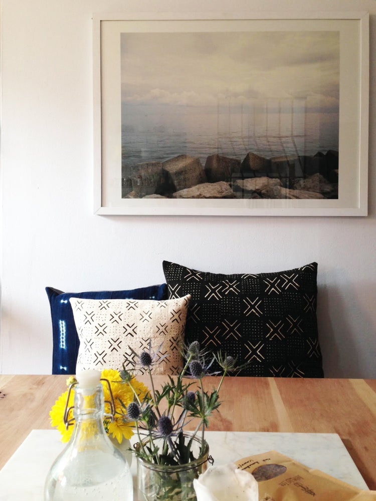 African mudcloth and indigo pillows in Brooklyn at the breakfast table. Fine art photography on the wall.