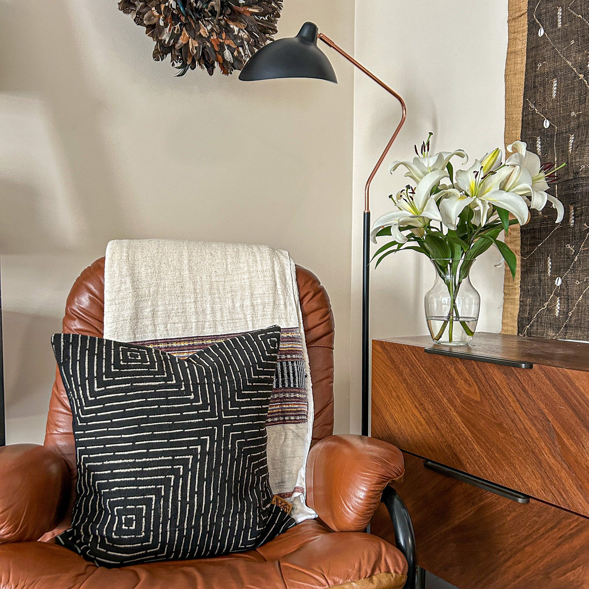 Mudcloth Maze pillow and other African decor styled in a modern home, as seen in "The African Decor Edit".