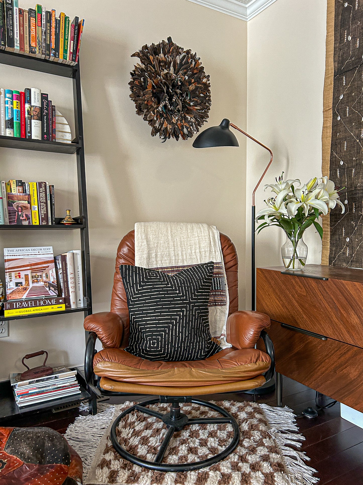 Mudcloth Maze pillow and other African decor styled in a modern home, as seen in "The African Decor Edit".