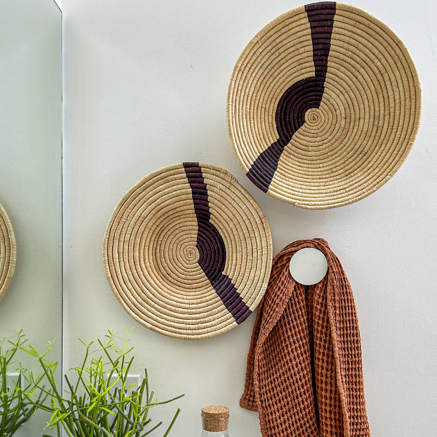 Decorative African baskets with African art on gallery wall. Fair Trade made in Uganda and Rwanda.