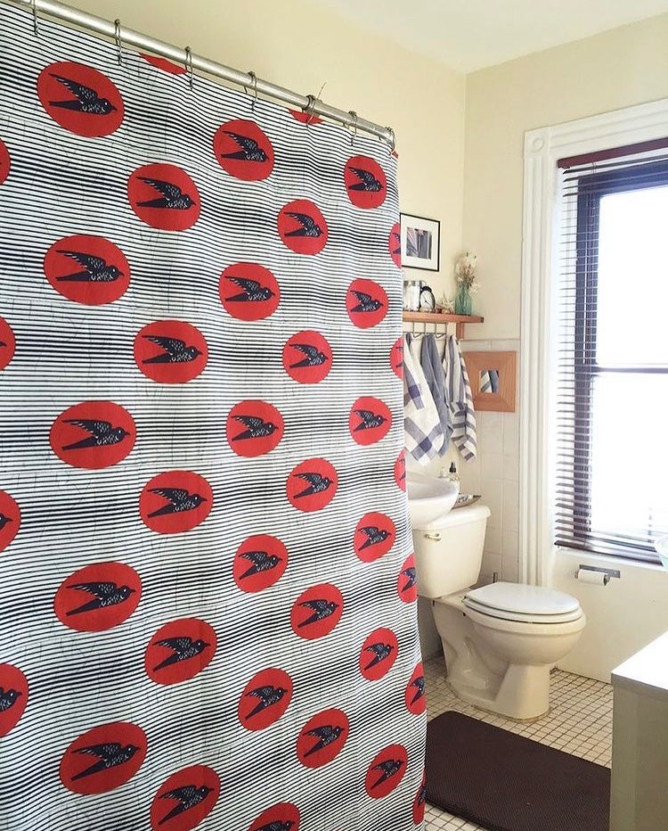 African fabric shower curtain in black and white, modern bathroom. Global homes and eclectic interior design in Brooklyn, Washington, DC, San Francisco.