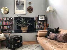 Load image into Gallery viewer, Black mudcloth pillows with minimalist designs styled with African art and Mudcloth furniture. Modern pillows made in USA, designed in Mali. Seen here with African art.
