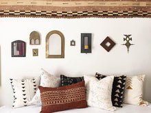 Load image into Gallery viewer, ﻿Sienna brown mudcloth pillows with minimalist geometric designs. Modern pillows made in USA, designed in Mali. Seen here with African art and Kuba cloth wall accent.
