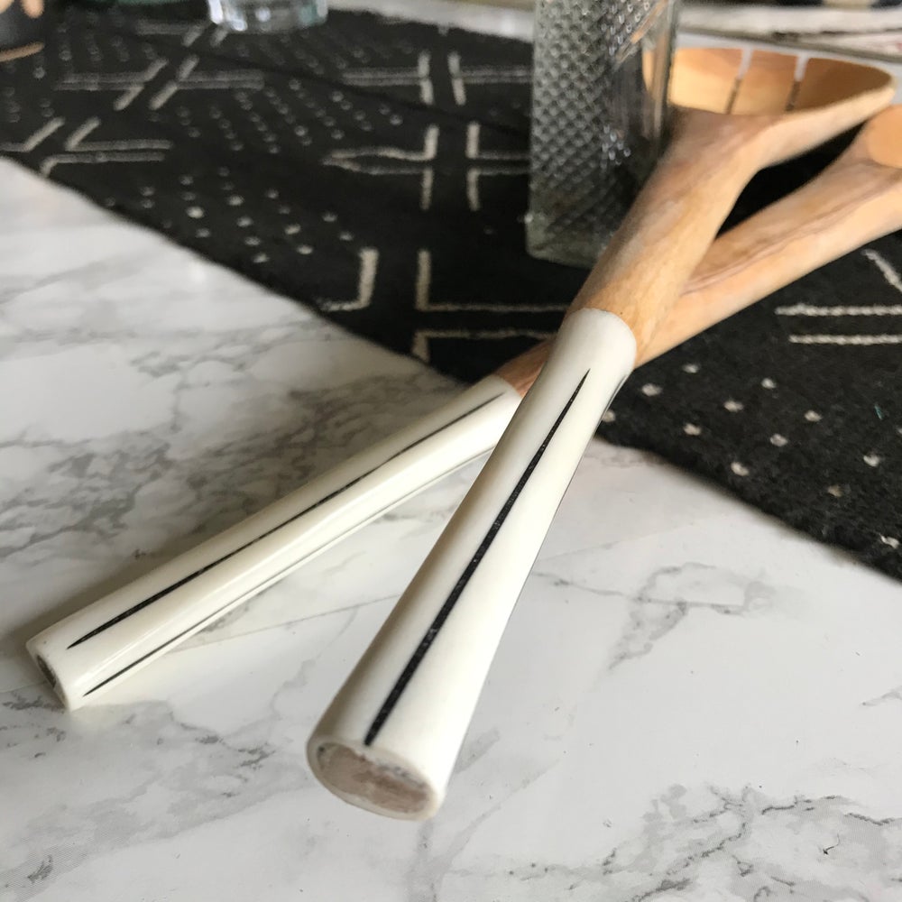 Handcrafted Fair Trade serveware and home goods made in Uganda, Sustainable African salad servers for housewarming and wedding registry gifts. Handcarved acacia wood and bone on mudcloth table runner.