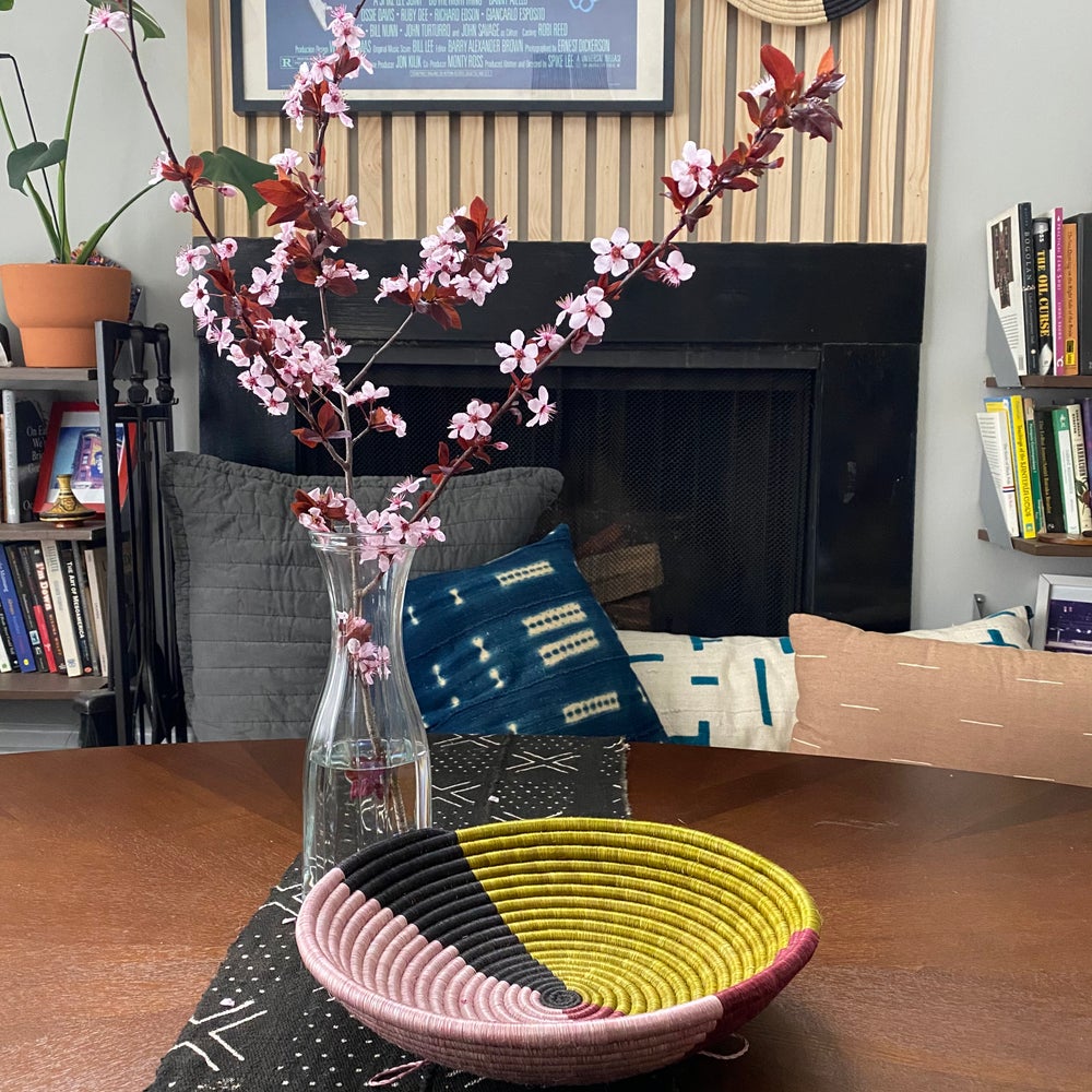 African basket, Fair Trade made in Uganda. Decorative and African art on table with mudcloth pillows.