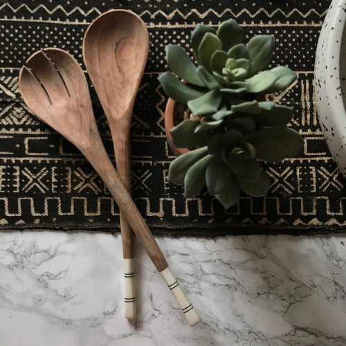 Fair Trade serveware and home goods made in Uganda, Sustainable African salad servers for housewarming and wedding registry gifts. Handcarved acacia wood and bone on mudcloth table runner.