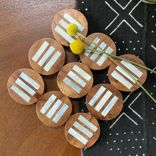 Handcrafted Pot holder African tableware. Fair Trade home goods and table top trivet, made in Uganda from acacia wood and cowhorn. Perfect for housewarmings and wedding gifts. Seen here with mudcloth table runner.