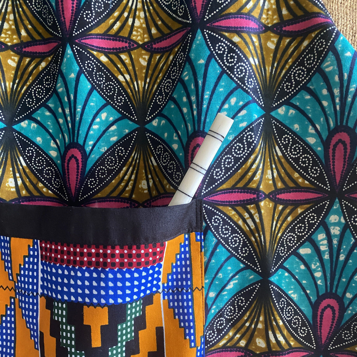 Handcrafted African wax print apron made in Uganda. Perfect for housewarming and wedding gitfs. Excellent for entertaining guests during the holidays, Thankgiving, Christmas, and more.