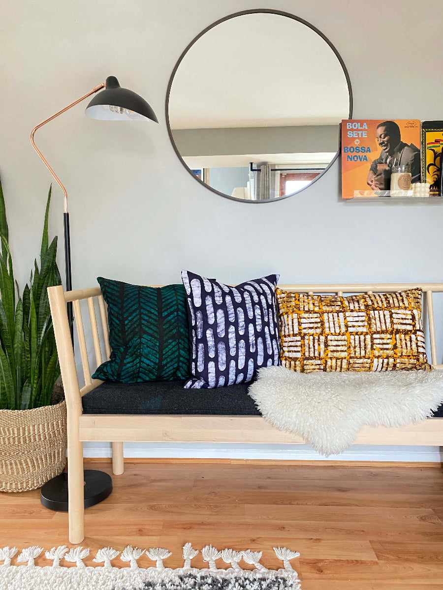 Batik and mudcloth textile home goods in modern Boho home, pillows made in Tanzania. African art.