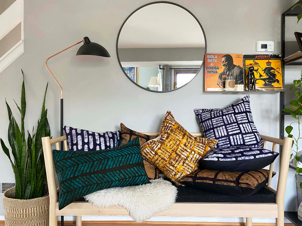 Batik and mudcloth textile home goods in modern Boho home, pillows made in Tanzania. African art.