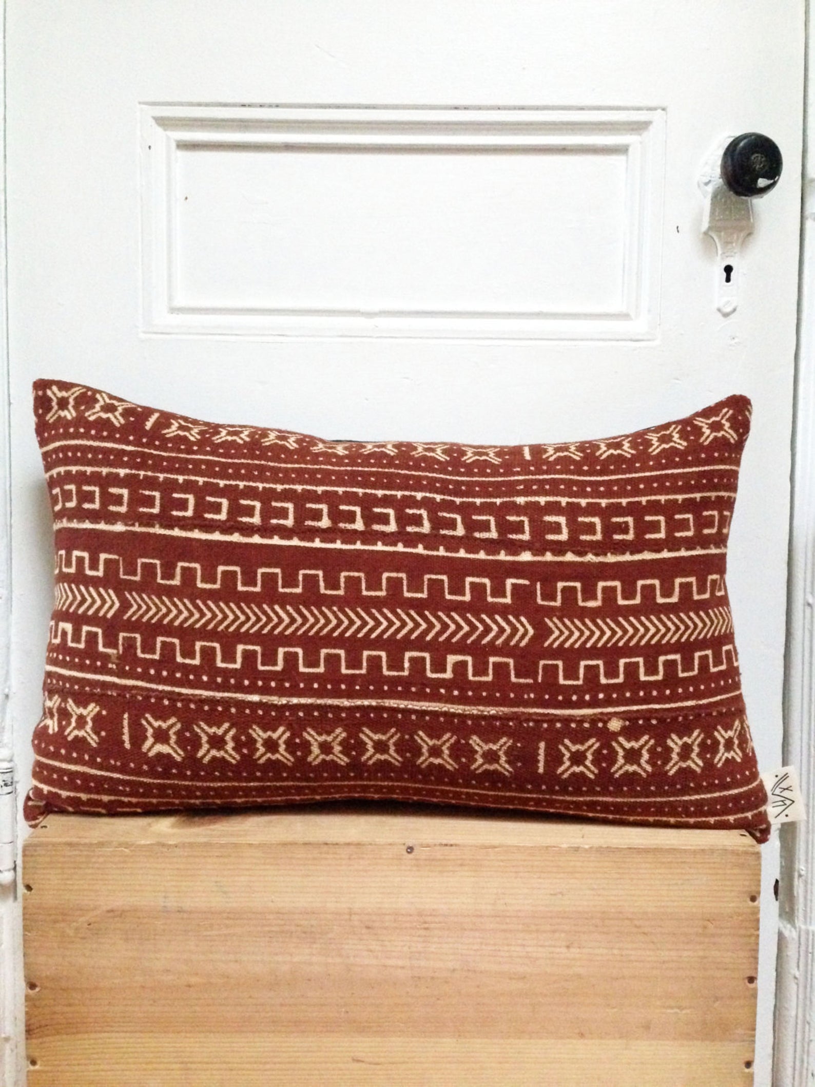 ﻿Sienna brown mudcloth pillows with minimalist geometric designs. Modern pillows made in USA, designed in Mali. Seen here with African art.