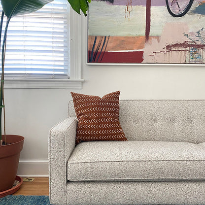 Sienna brown mudcloth pillows with minimalist geometric designs. Modern pillows made in USA, designed in Mali. Seen here with African art.