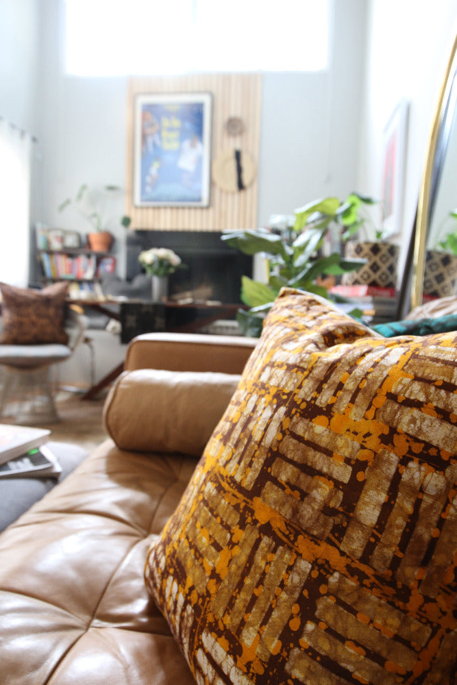 Batik and mudcloth textile home goods in modern Boho home, pillows made in Tanzania. African art.