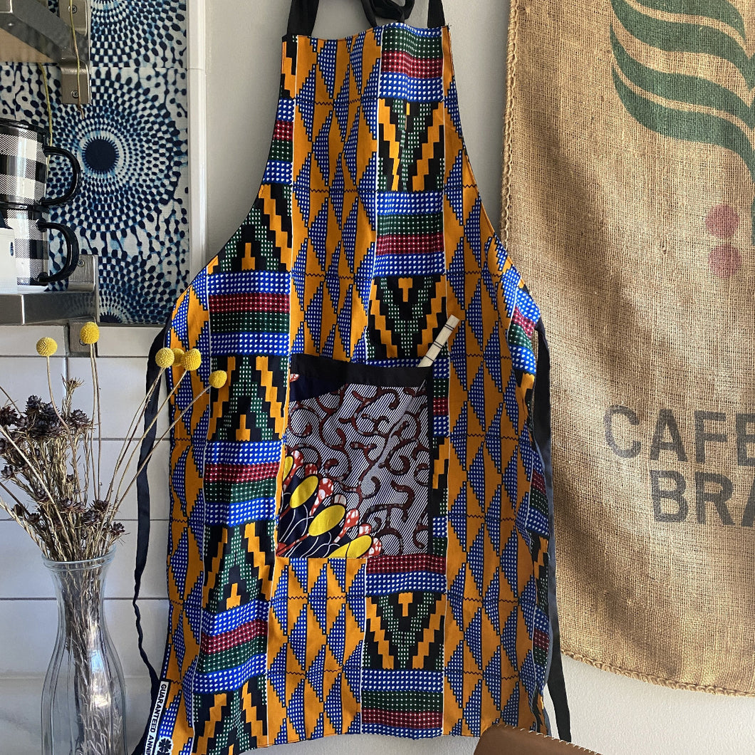 Handcrafted African wax print apron made in Uganda. Perfect for housewarming and wedding gitfs. Excellent for entertaining guests during the holidays, Thankgiving, Christmas, and more.