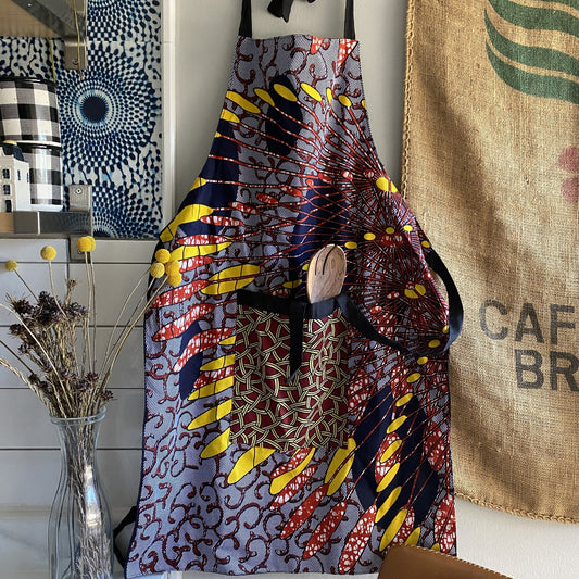 Handcrafted African wax print apron made in Uganda. Perfect for housewarming and wedding gitfs. Excellent for entertaining guests during the holidays, Thankgiving, Christmas, and more.