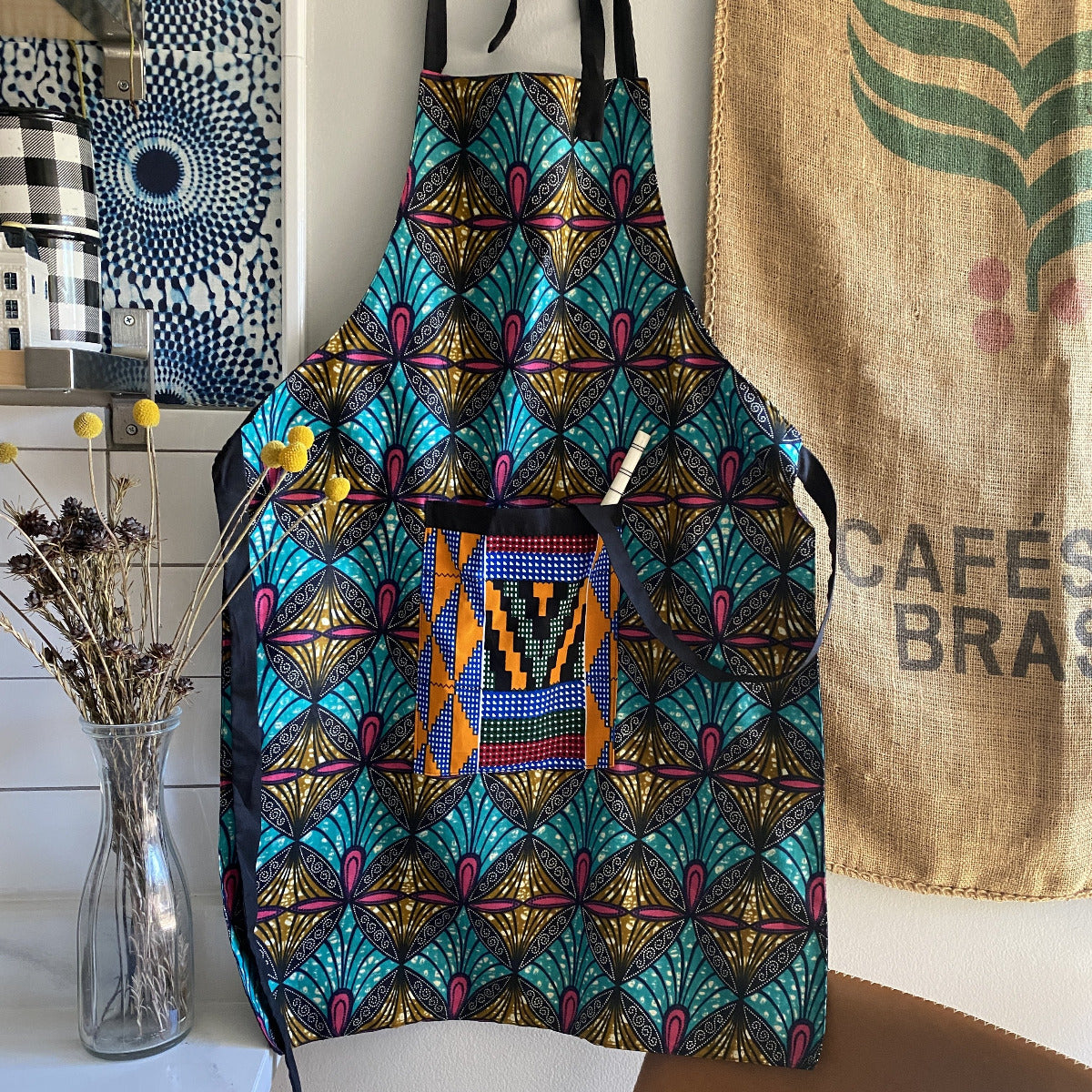 Handcrafted African wax print apron made in Uganda. Perfect for housewarming and wedding gitfs. Excellent for entertaining guests during the holidays, Thankgiving, Christmas, and more.