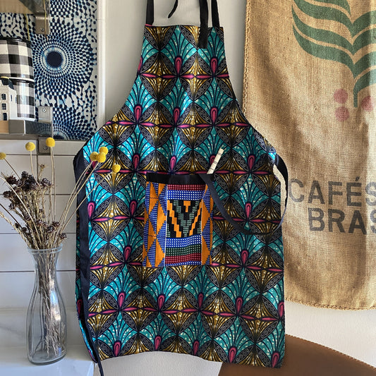 Handcrafted African wax print apron made in Uganda. Perfect for housewarming and wedding gitfs. Excellent for entertaining guests during the holidays, Thankgiving, Christmas, and more.