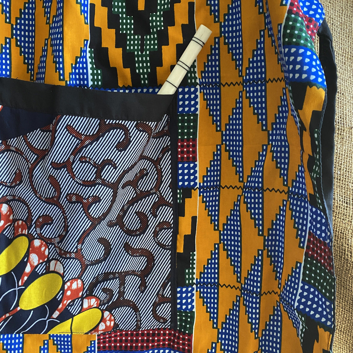 Detail of Handcrafted African wax print apron made in Uganda. Perfect for housewarming and wedding gitfs. Excellent for entertaining guests during the holidays, Thankgiving, Christmas, and more.