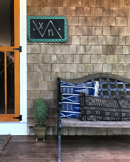 Blue Handcrafted vintage Baule pillow with accent embroidery. Ivory Coast textile and African home goods. At a summerhome in Martha's Vineyard with a mudcloth pillow.